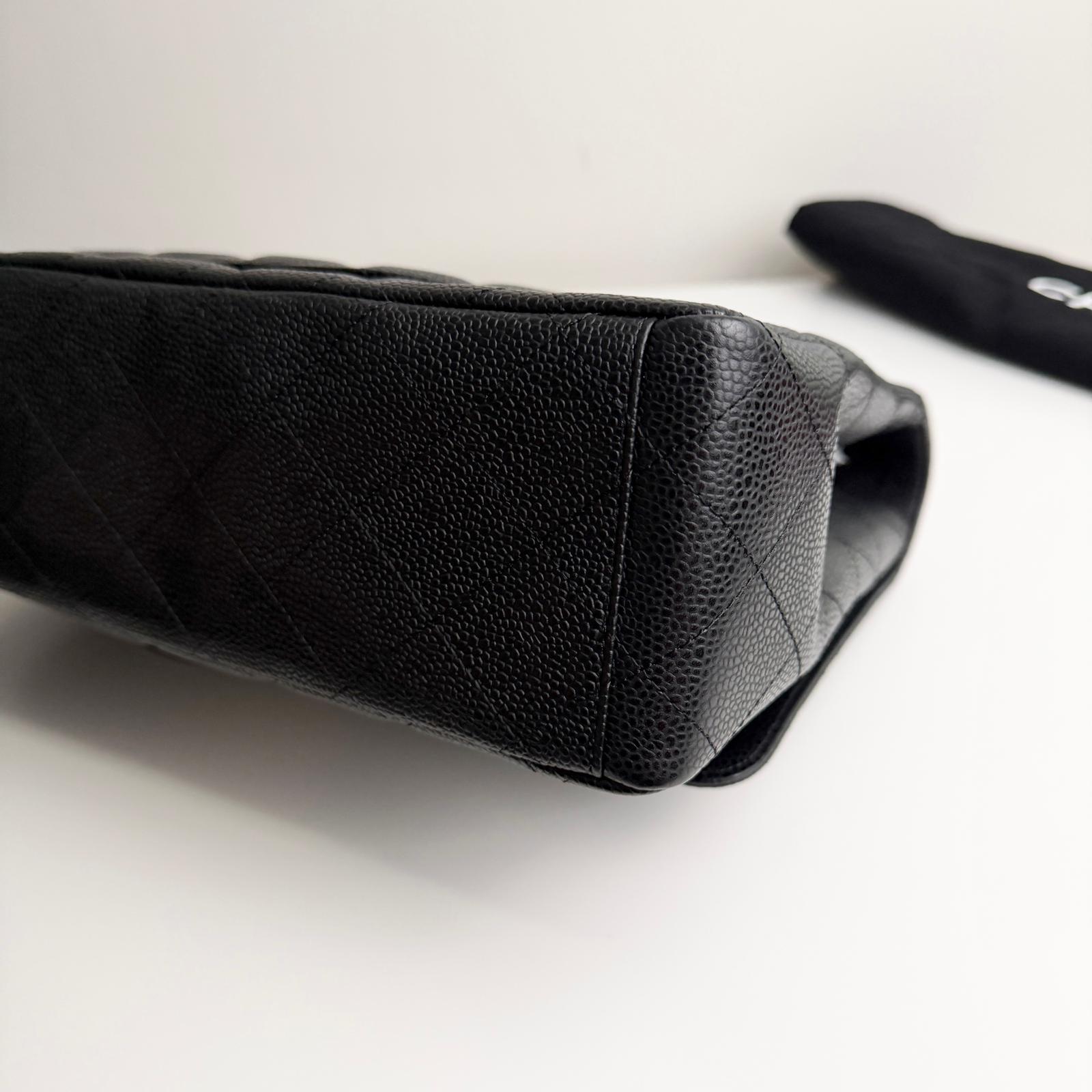Black quilted leather pouch on a white surface