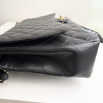 将图片加载到图库查看器，Black quilted handbag on a white background
