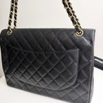将图片加载到图库查看器，Black quilted handbag with gold chain strap on a white background
