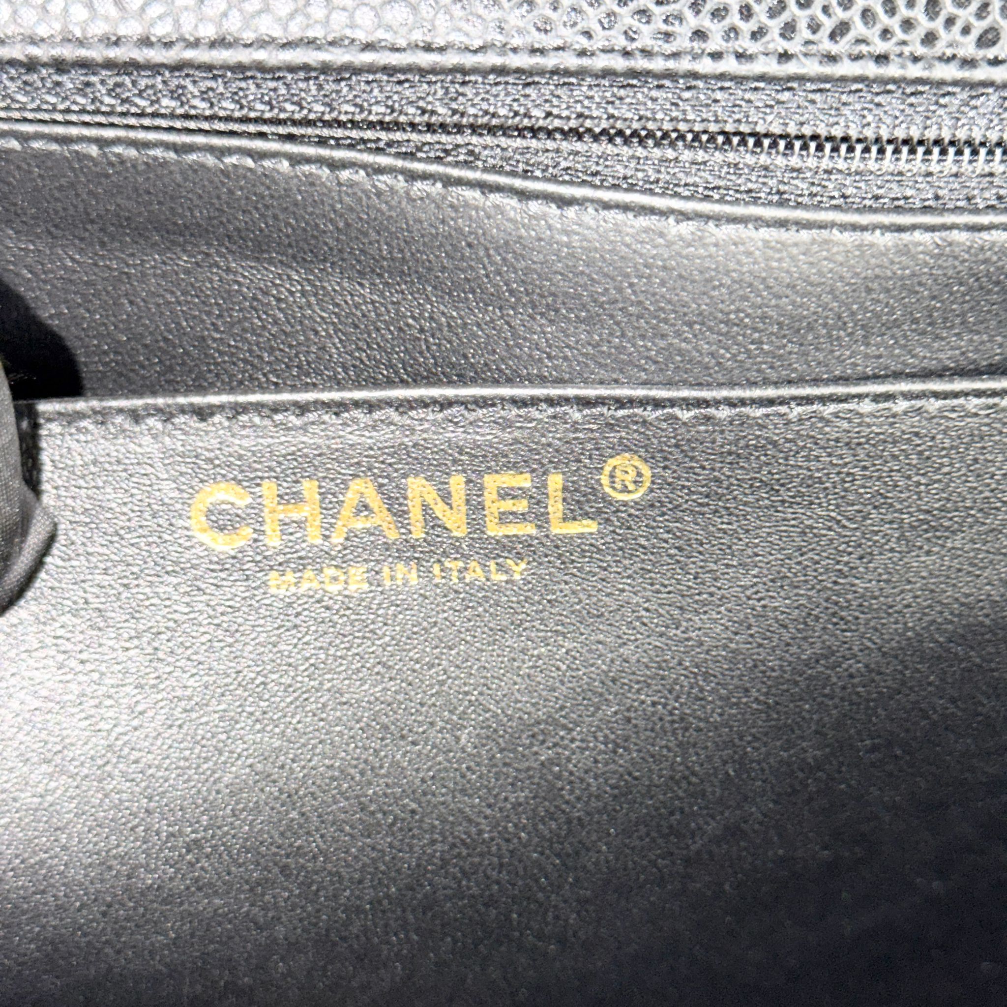 Close-up of a Chanel handbag with gold logo and 'Made in Italy' text.