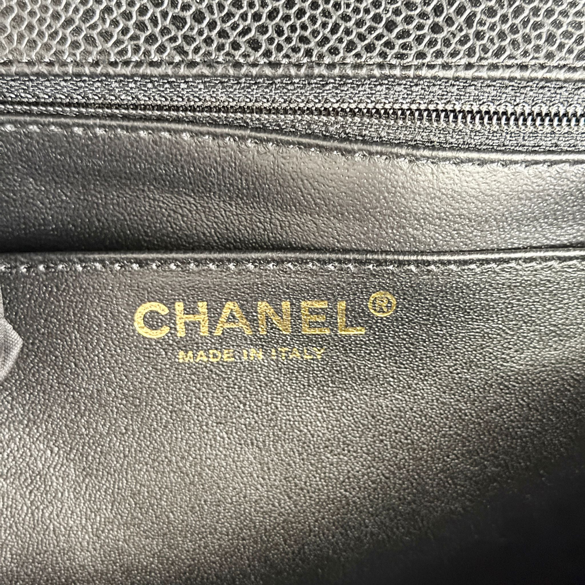 Close-up of a Chanel handbag with gold logo and 'Made in Italy' text.