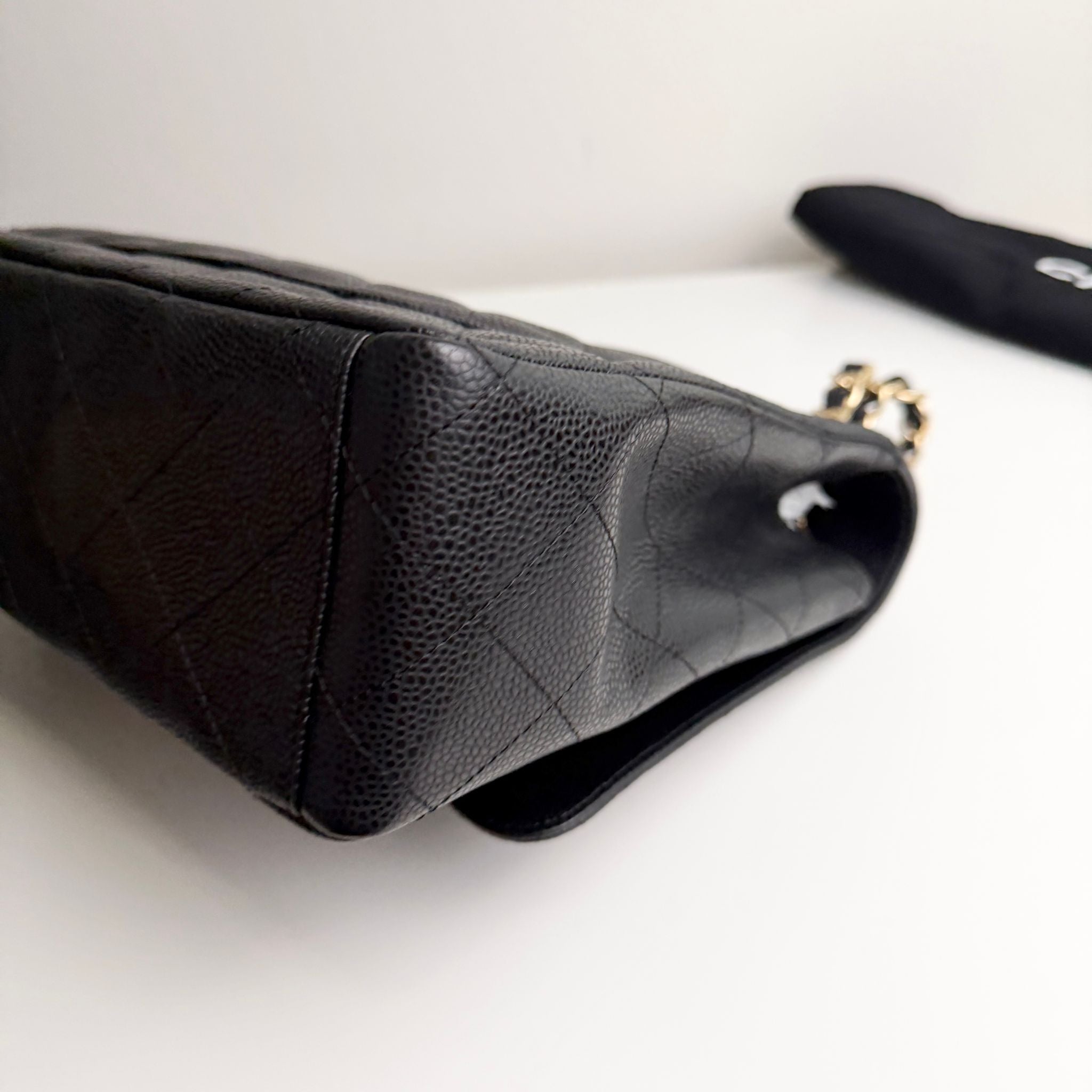 Black textured handbag on a light background
