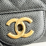 将图片加载到图库查看器，Close-up of a Chanel logo on a textured black surface
