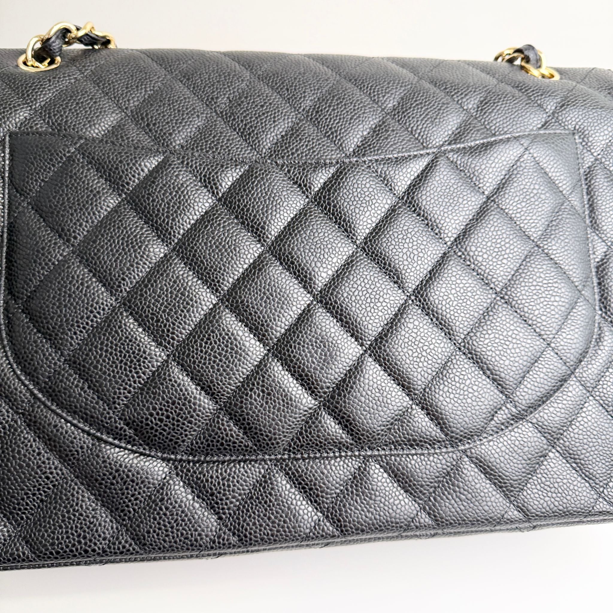 Quilted gray handbag on a white background