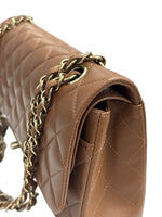 将图片加载到图库查看器，Close-up of a brown quilted handbag with gold chain strap on a white background
