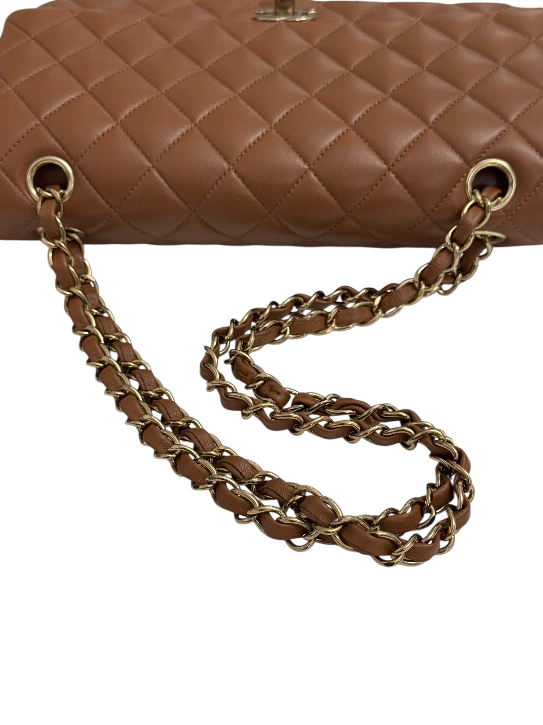 Brown quilted handbag with a gold chain strap on a white background