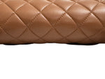 将图片加载到图库查看器，Close-up of a brown quilted leather surface
