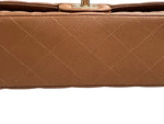 将图片加载到图库查看器，Close-up of a brown quilted handbag with a white background
