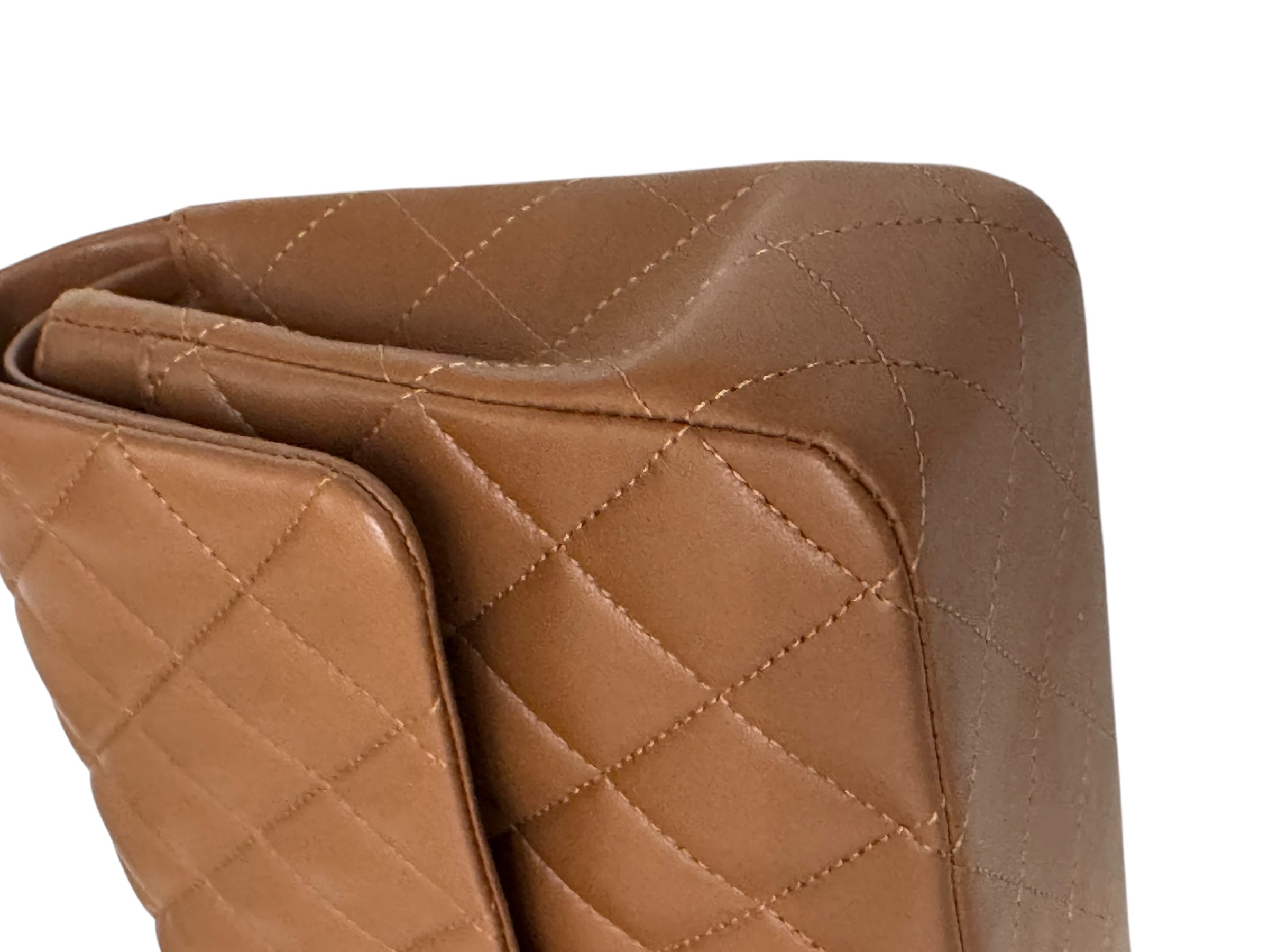Close-up of a brown quilted leather product on a white background