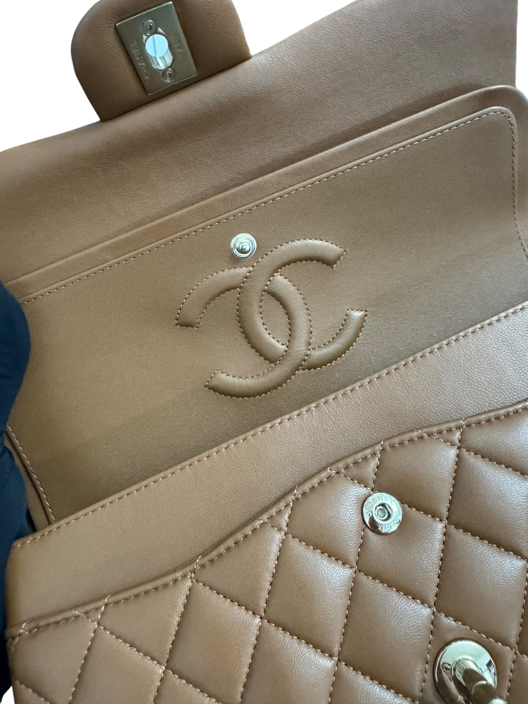 Close-up of a beige quilted handbag with Chanel logo