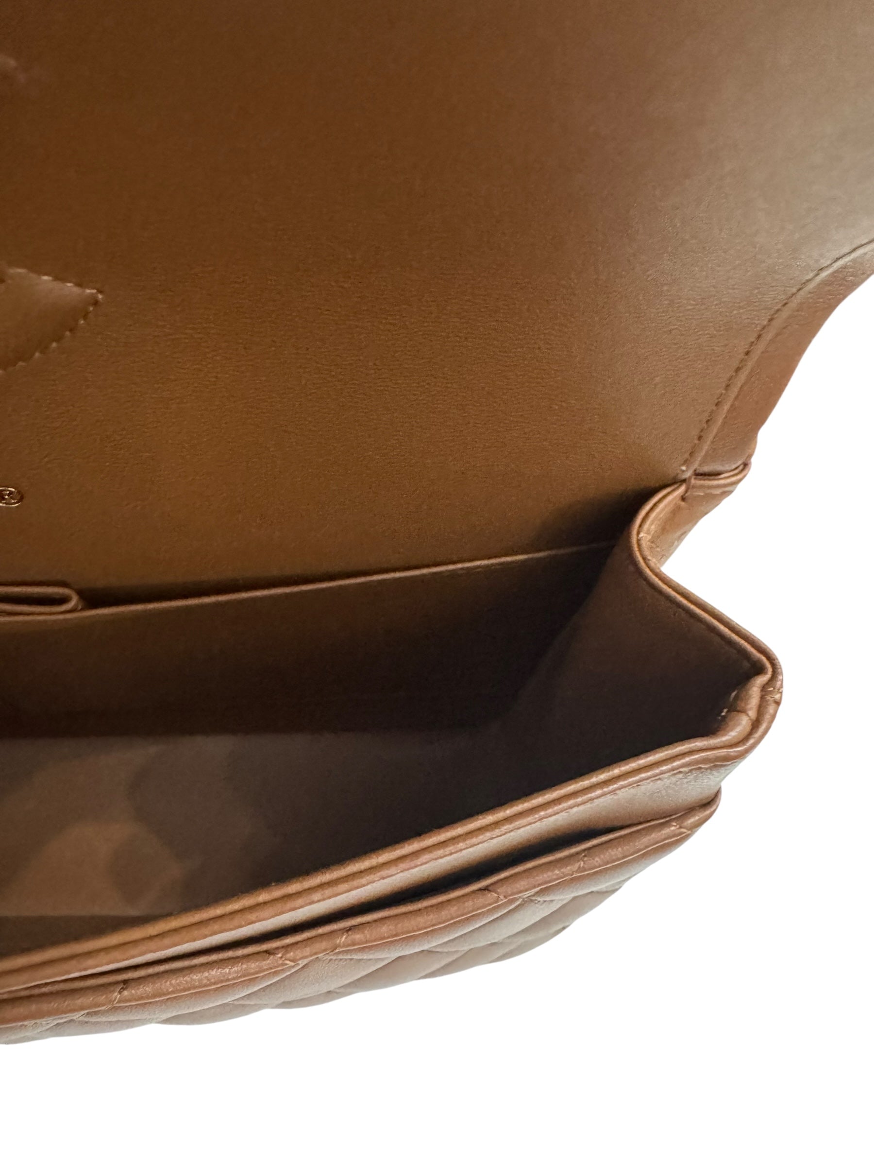 Close-up of a brown leather bag with a white interior