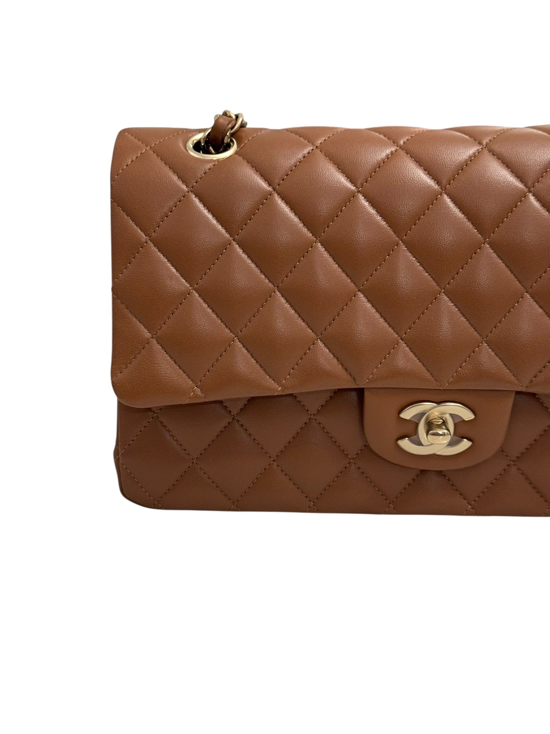 Brown quilted handbag with gold hardware on a white background