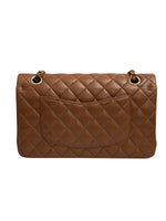 将图片加载到图库查看器，Brown quilted handbag on a white background
