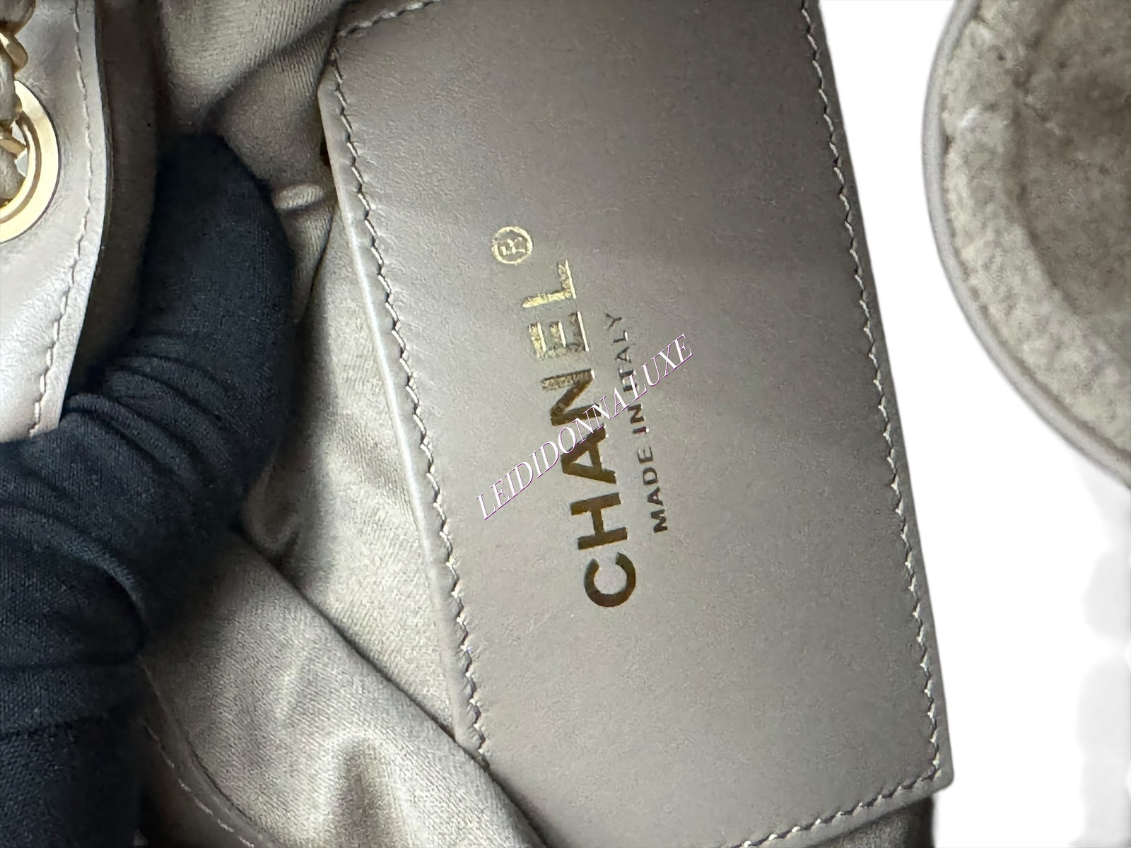 Close-up of a Chanel handbag with visible branding.