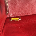 将图片加载到图库查看器，Close-up of a red leather product with a gold tag and number on a textured surface.
