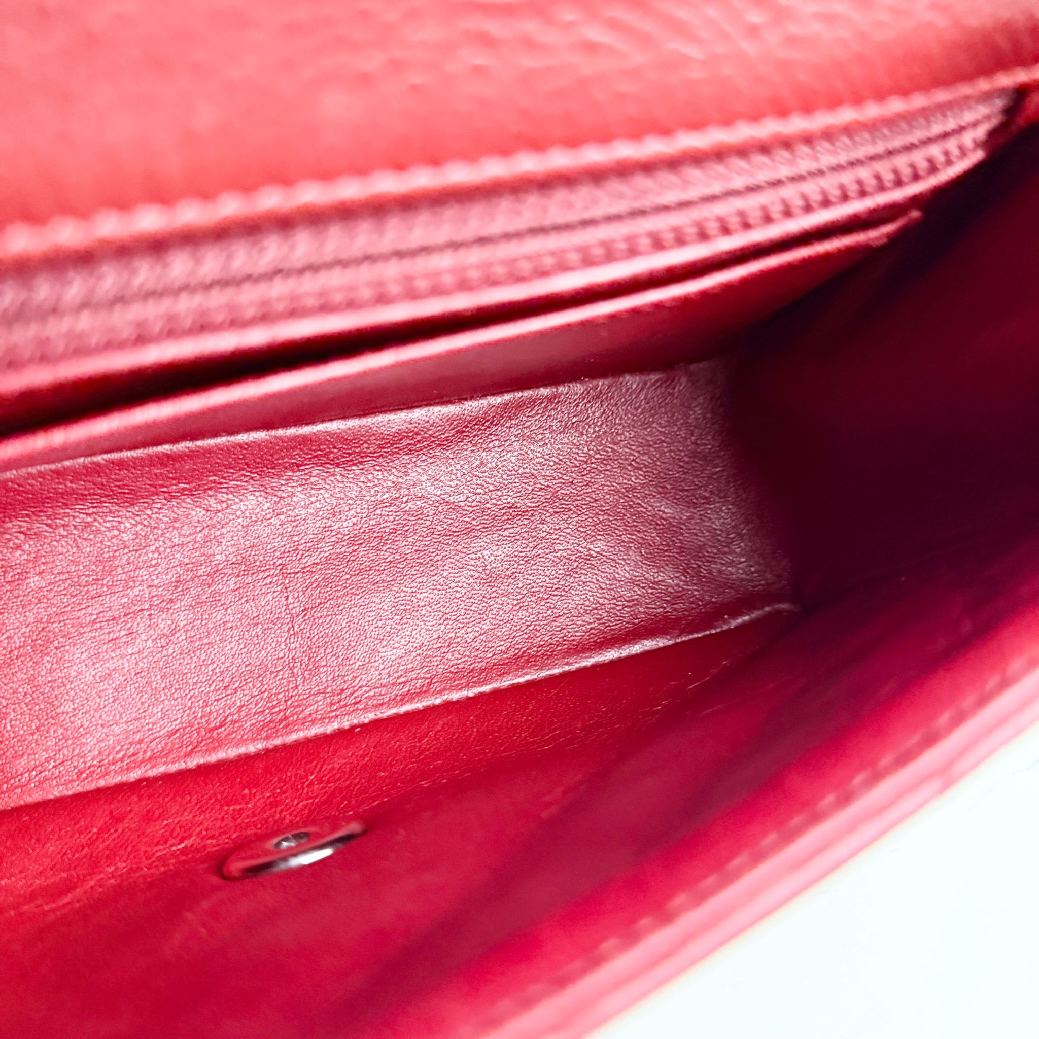 Close-up of a red leather wallet with a white background