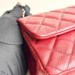 将图片加载到图库查看器，Close-up of a red quilted handbag with a gray coat next to it.
