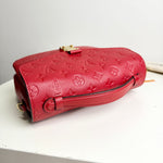 Load image into Gallery viewer, Red embossed handbag on a white surface
