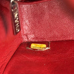 Load image into Gallery viewer, Close-up of a red leather bag with a visible brand tag.
