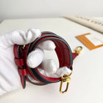 Load image into Gallery viewer, Red and black leather strap with gold clasp held by a gloved hand on a white surface.
