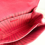 Load image into Gallery viewer, Close-up of a red leather handbag with visible stitching

