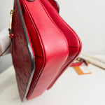 Load image into Gallery viewer, Close-up of a red handbag with a blurred background
