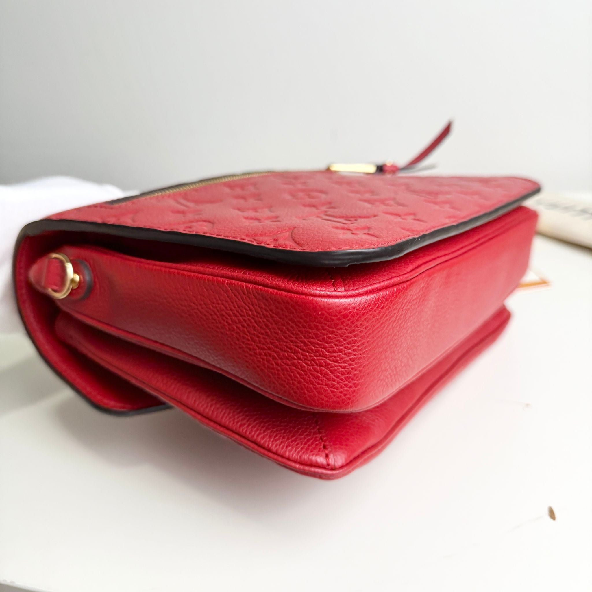 Red textured handbag on a light background