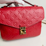 Load image into Gallery viewer, Red handbag with gold lock detail on a white background
