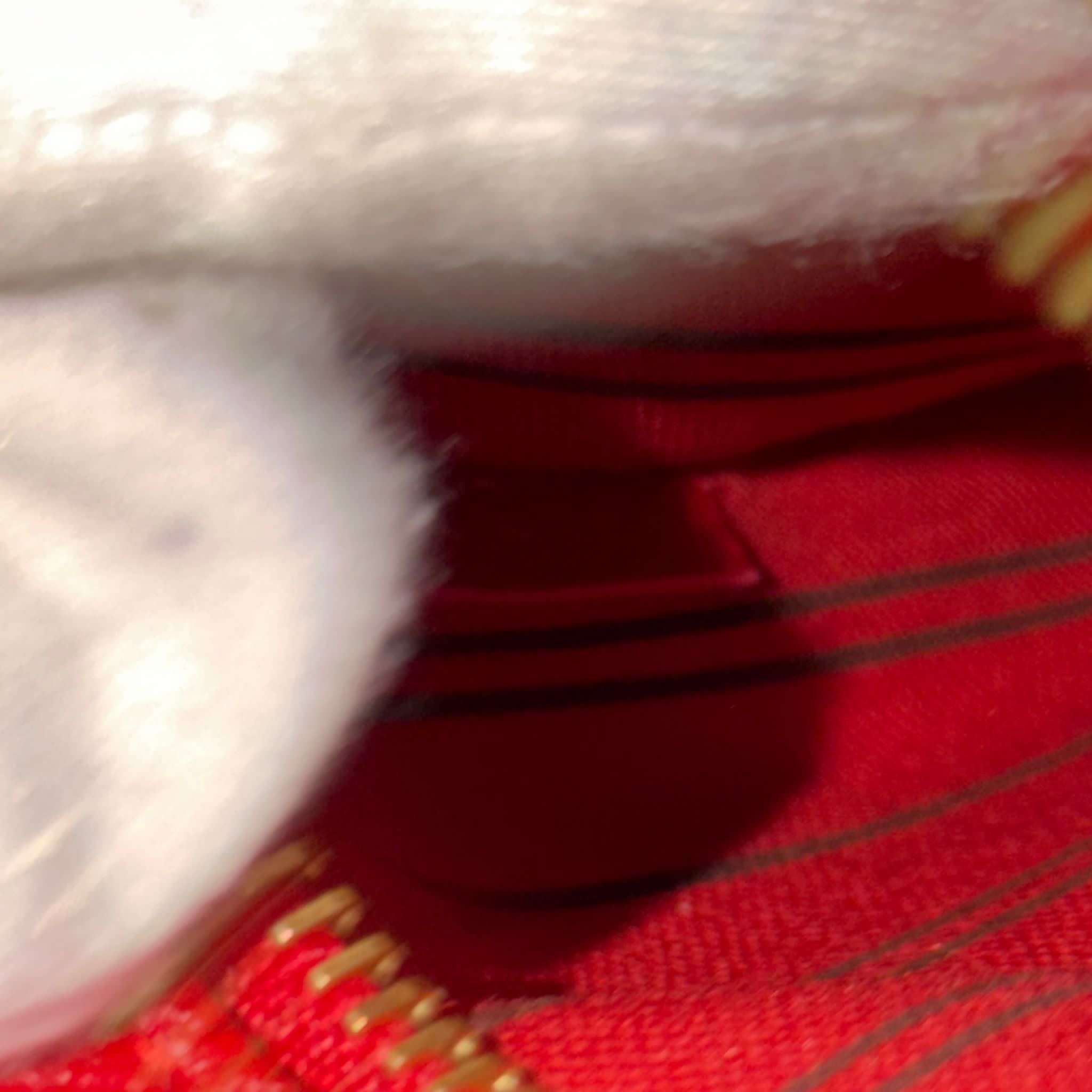 Close-up of a red fabric with white and gold trim