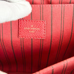 Load image into Gallery viewer, Close-up of a red Louis Vuitton bag with a visible logo.
