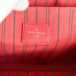 Load image into Gallery viewer, Close-up of a red Louis Vuitton bag with a visible logo.
