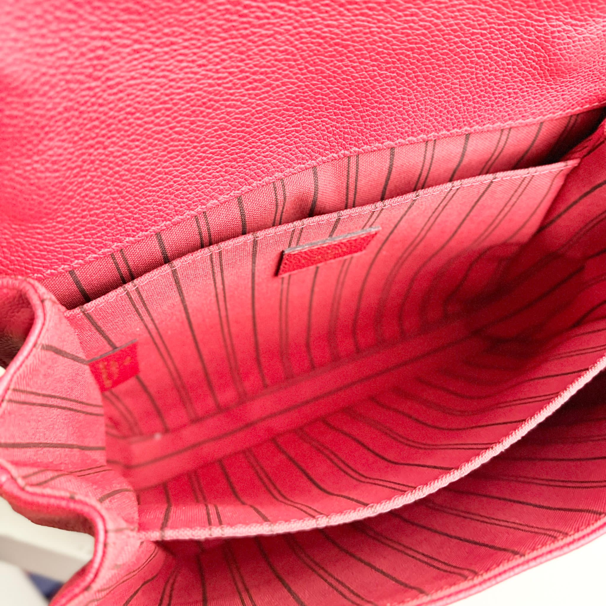 Close-up of a pink leather bag with visible stitching